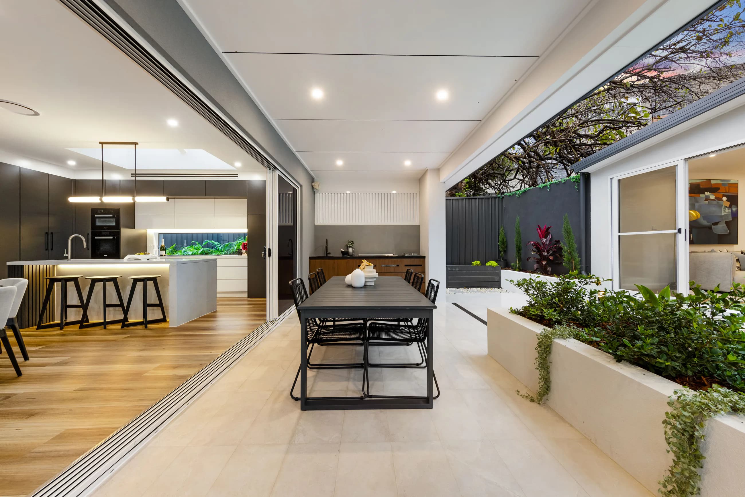 Cowell Renovation connection between the kitchen, covered outdoor area, and landscaped courtyard